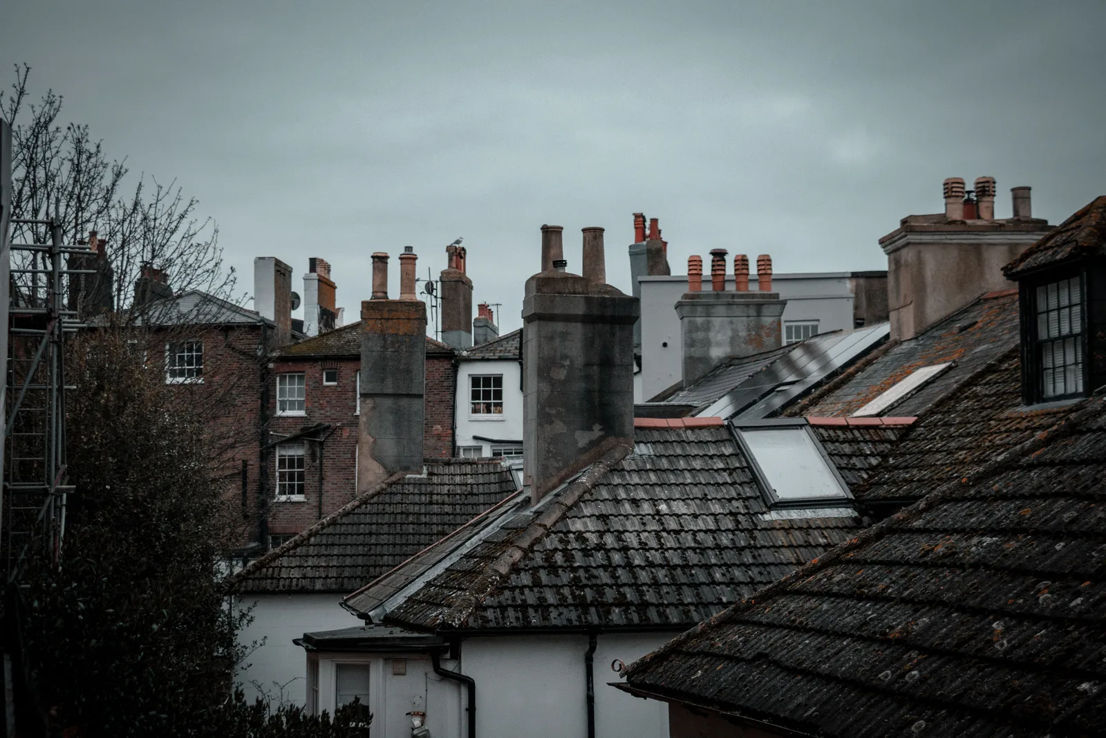 Discover the rustic charm of rooftops in Hastings, England, featuring classic chimneys and urban architecture. National Fire Code of Canada chimney sweep: who enforces it