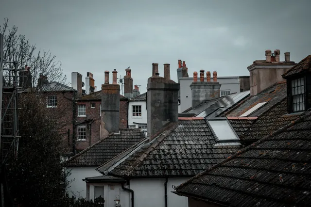 Discover the rustic charm of rooftops in Hastings, England, featuring classic chimneys and urban architecture. National Fire Code of Canada chimney sweep: who enforces it